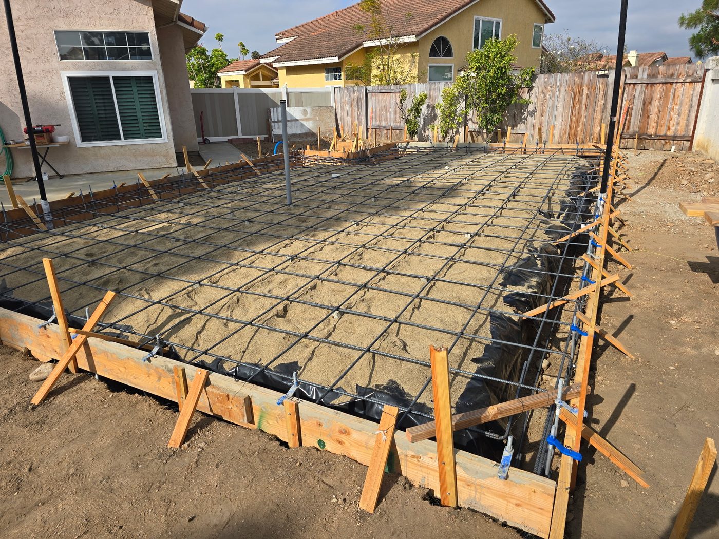 New home foundation in San Diego — formed with a full rebar grid, prepped for the concrete slab pour